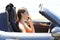 Profile of a car driver calling on phone on vacation