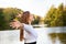 Profile. cheerful young adult girl posing near lake. Autumn, yellow, fall.