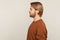 Profile of confident calm handsome man with neat hair and beard wearing sweatshirt standing, looking to side