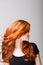 Profile of a cool redhead flicking her hair