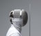 Profile of a fencer in fencing mask with the sword.Studio shot