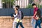 Profile of a group of four students of different ethnicities walking in the street