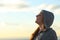 Profile of a happy teen breathing fresh air on the beach