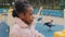 Profile lonely little girl sad stands on playground close-up bored child outdoors serious african american pupil looking