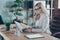 Profile photo of amazing blond business lady resourceful person looking seriously notebook texting colleagues sit boss