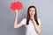 Profile photo of attractive lady hold hand big red paper mind cloud creative intelligent person arm on chin thinking