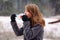 Profile photo. Caucasian blonde girl removes the medical mask from her face to the side to taste the aroma of hot tea in