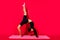Profile photo of charming ballerina sporty lady stretch mat wear black cropped top isolated red color background