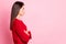 Profile photo of charming serious lady crossed arms calm expression look empty space wear red sweater isolated pink