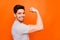 Profile photo of cool self-confident guy raise fist arm showing strong perfect shape biceps amazing training results