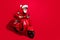 Profile photo of crazy santa claus ride motorcycle fast wear goggles x-mas hat suit on red color background