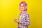 Profile photo of funny pink hairdo young lady hear music hold telephone wear plaid shirt isolated on yellow color