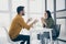 Profile photo of handsome guy and his pretty lady looking tender eyes drinking hot beverage sitting chairs opposite in