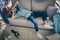 Profile photo of hipster crazy guy lying sofa holding head intoxicated food underwear bottles lying floor had stag party