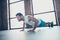 Profile photo of macho sportsman guy do push ups plank hands leaning floor determined trainer sportswear tank-top shorts