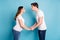 Profile photo of optimistic pregnant couple hold hands blow kisses wear white t-shirt jeans isolated on teal color