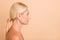 Profile photo of perfect beauty aged lady look side empty space nude shoulders isolated pastel beige color background