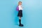 Profile photo of positive schoolgirl wear backpack white shirt stockings skirt shoes  blue color background