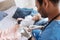 Profile photo of smiling family doctor while treating his patient