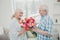 Profile photo of two adorable aged people cute pair anniversary holiday surprise big red tulips bunch bright flat