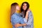 Profile photo of two adorable girls dark skin hugging closed eyes kiss cheek isolated on yellow color background