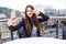 Profile photo of young lady, having lunch on open air light terrace outdoors.