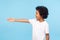 Profile of polite cheerful preschool boy with curly hair in white T-shirt giving hand to handshake