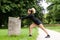 Profile portrait of beautiful athlete stretching outdoors