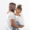 Profile portrait of black father and daughter bonding over white