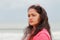 A profile portrait head shot of a beautiful young Indian woman standing alone on the shores of Chennai in the evening