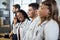 Profile portrait. Multiracial group of four doctors in lab coats standing in a row.