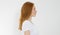 Profile portrait of red haired caucasian girl with long and shiny straight female hair  on white background . Beautiful