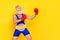 Profile portrait of sporty concentrated aged man hands boxing gloves punch empty space isolated on yellow color