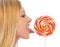 Profile portrait of teenage girl licking lollypop