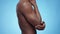 Profile portrait of unrecognizable black shirtless man massaging his aching elbow, suffering from bone pain
