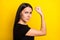 Profile portrait of young person hand showing flex biceps look camera isolated on yellow color background