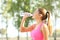 Profile of a runner hidrating drinking bottled water
