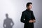 Profile of a seriously, strong man, with hair arranged, pose with attitude in the studio, on a white background.