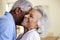 Profile Shot Loving Senior Couple Hugging At Home Together