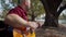 Profile shot of a man wearing a green mohawk playing guitar at park