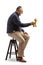 Profile shot of a mature man sitting on a chair and holding a giraffe toy