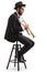 Profile shot of a trumpet player seated on a chair