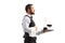 Profile shot of a waiter carrying a red wine decanter on a silver tray and walking