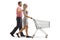 Profile shot of a young couple walking and pushing an empty shopping cart