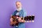 Profile side photo of aged man happy positive smile play guitar performance isolated over purple color background