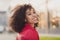 Profile side photo of cute shiny pretty charming wavy lady wear red jacket smiling outside urban city street