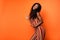 Profile side photo of dark skin attractive happy lady dance dream summer isolated on orange color background