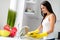 Profile side photo of neat positive housewife wash dishes after supper wearing yellow rubber protective gloves hold