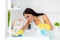 Profile side photo of positive house maid girl wearing dotted apron have cleaning house using yellow rubber gloves blue