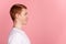 Profile side photo of young cheerful guy good mood look empty space isolated over pink color background